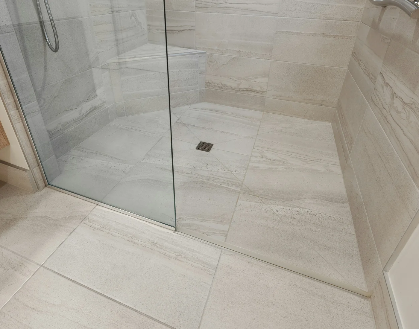 Tiled walk-in shower floor and walls