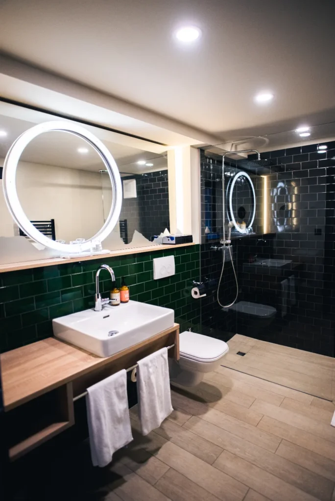 Deep green wall tile with a round mirror