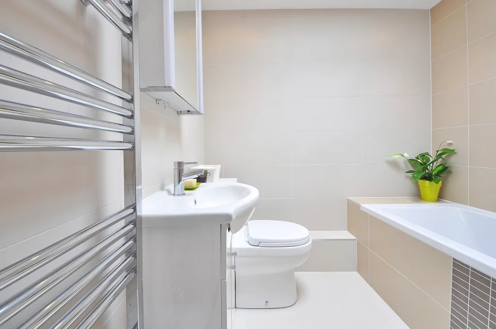 Bright minimal bathroom with heated towel rail