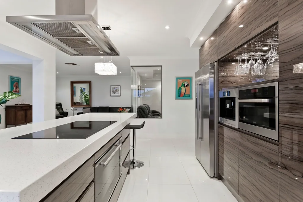 Handleless kitchen on large white floor tile