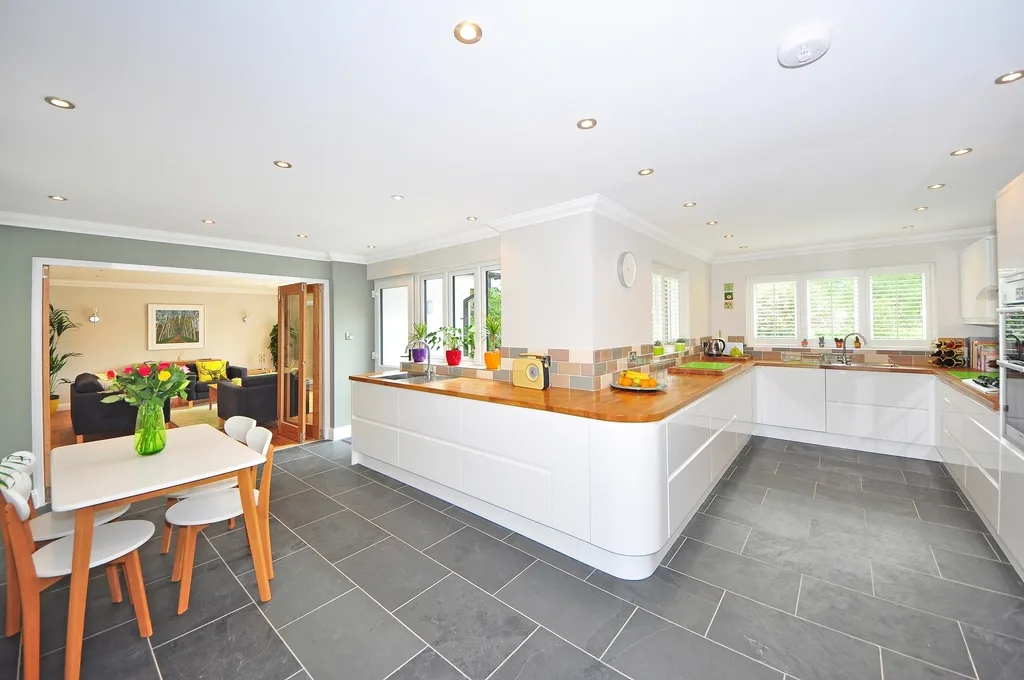 Open-plan kitchen and dining on grey floor tile